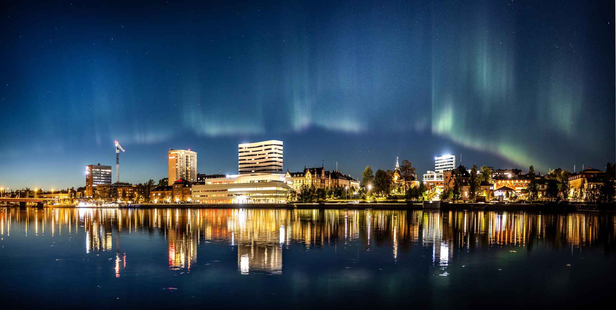 Nordlichter über der Skyline von Umeå.