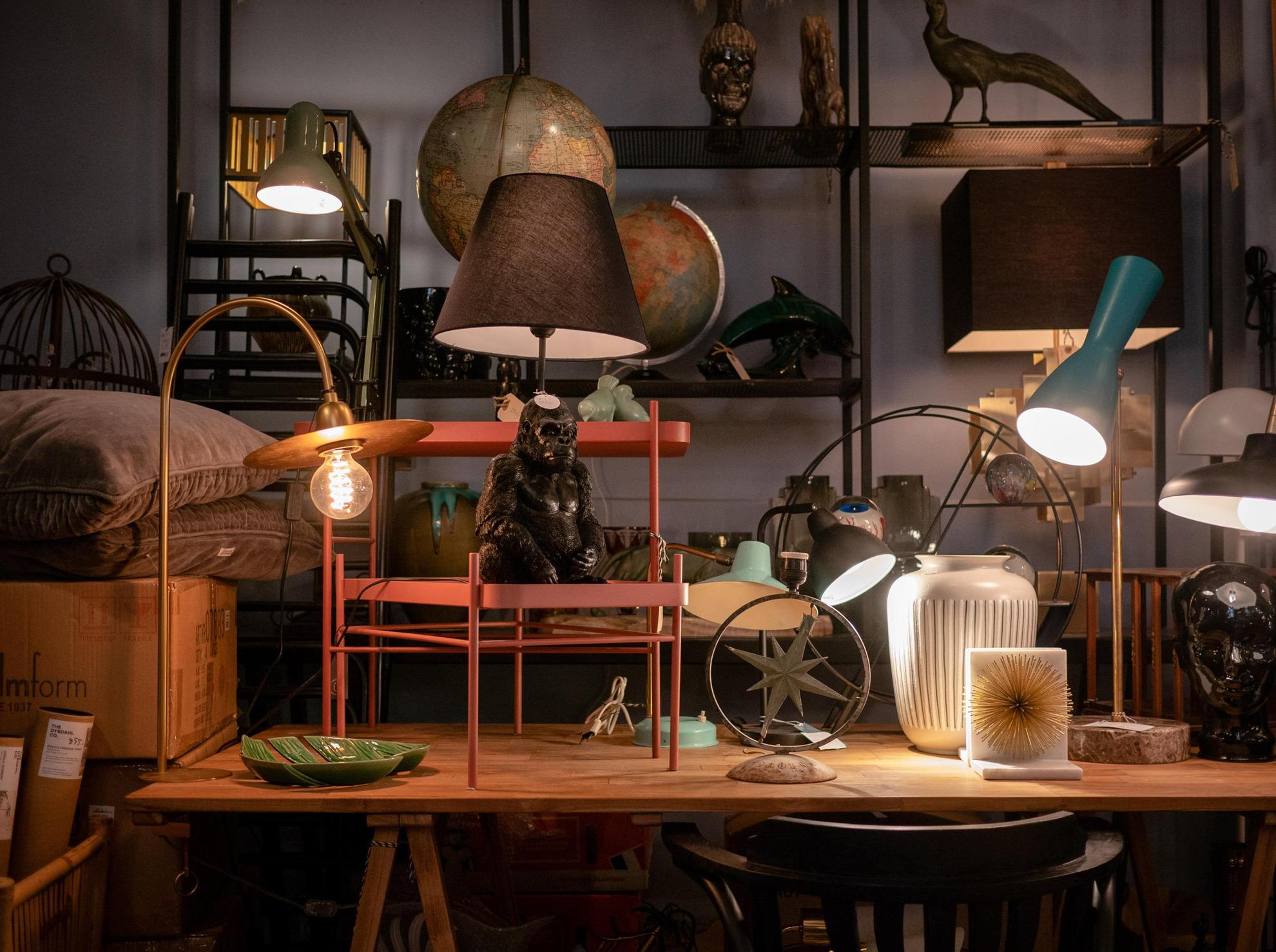 Ausstellung verschiedener Designartikel in einem Antiquitätengeschäft. Verschiedene Lampen, Möbel und Dekorationen.