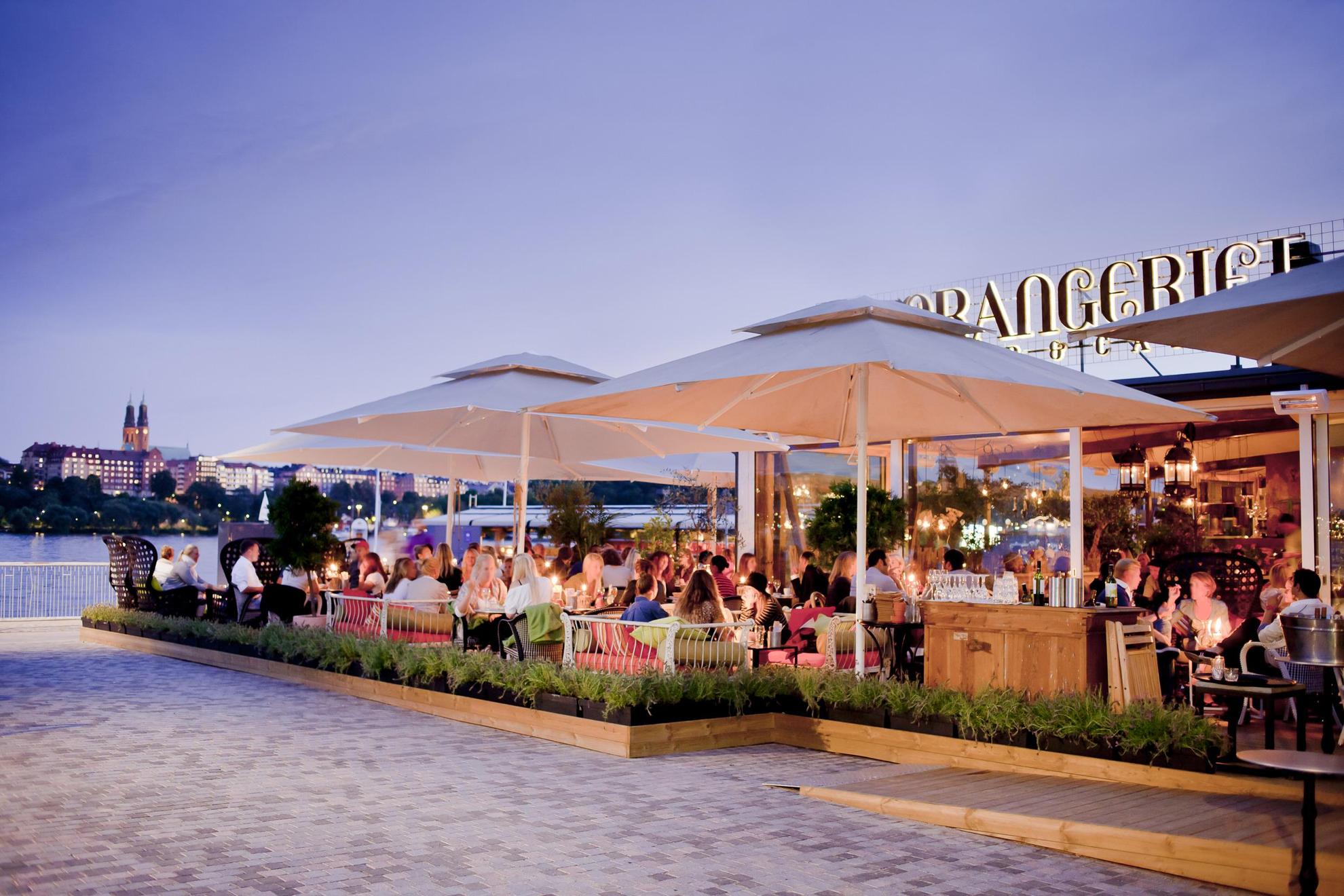 A restaurant called Orangeriet on a crowded summer evening, with Lake Mälaren in the background.